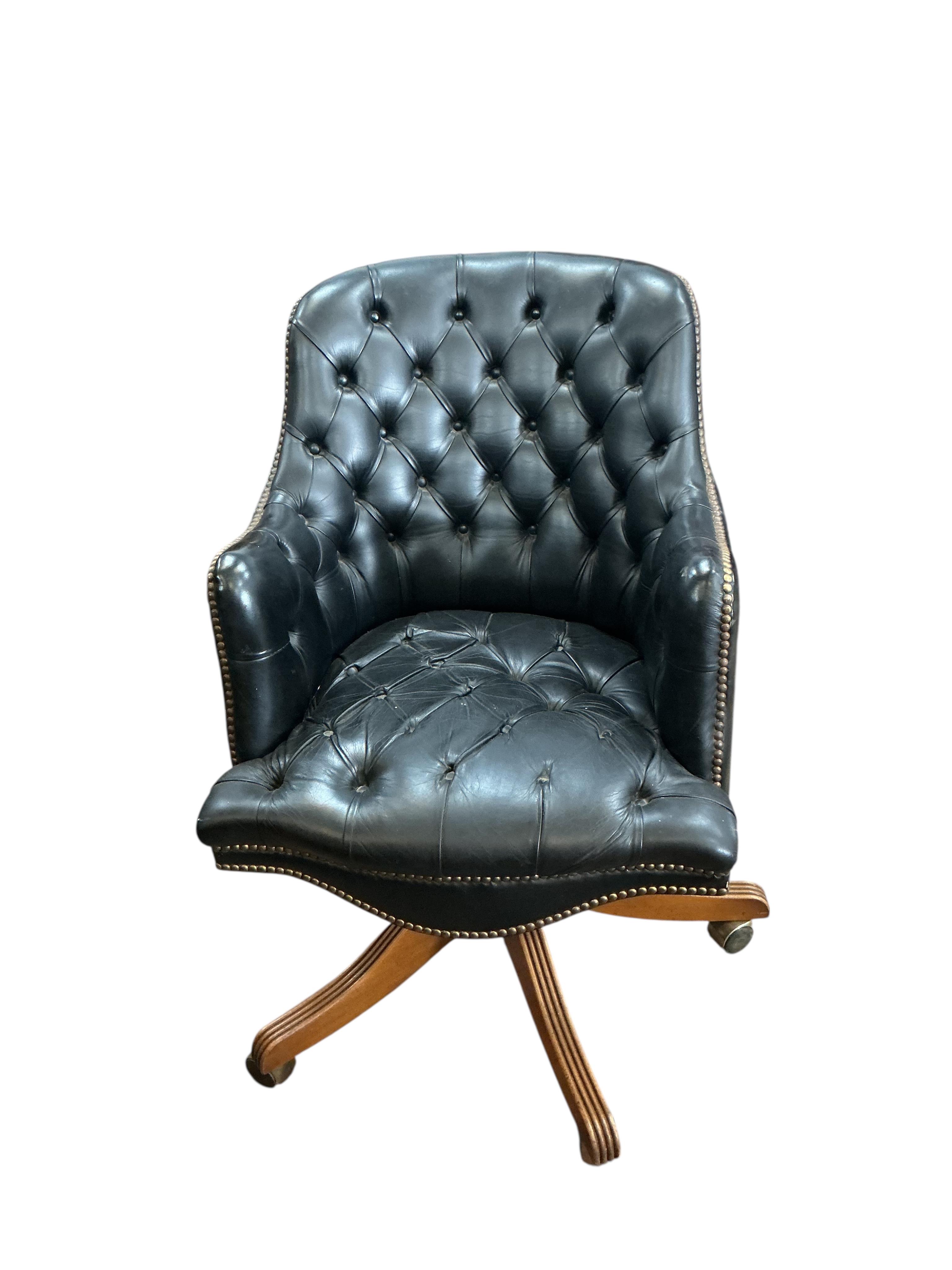 A buttoned leather swivel desk chair